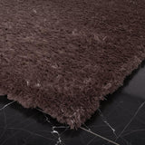 Vloerkleed bruin hoogpolig van wol – Vesuvio – detail van de rand