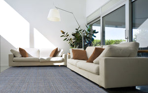 Tapis gris et beige tissé main en laine et viscose dans un salon contemporain, apportant chaleur et élégance à la pièce