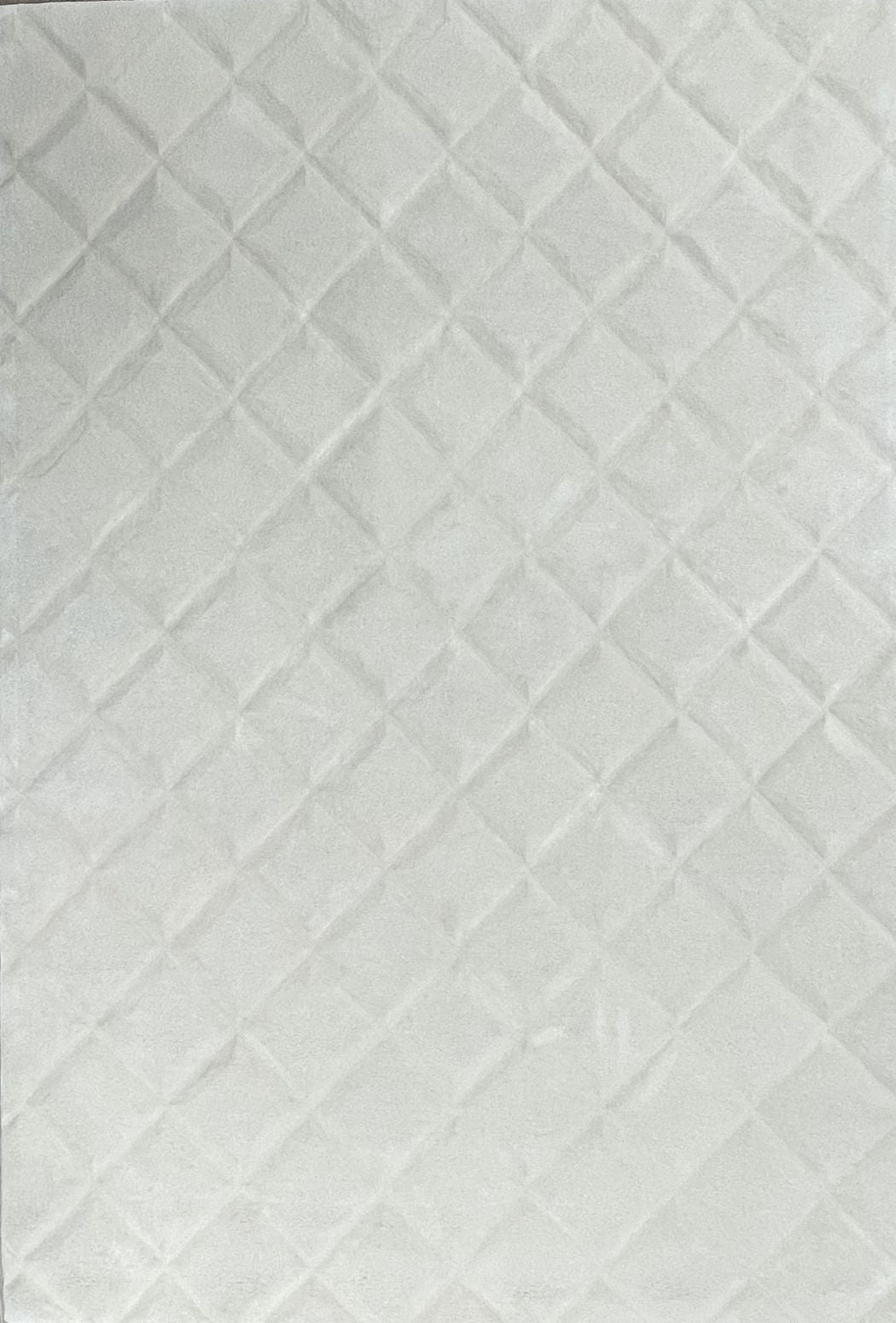 Tapis en laine de Nouvelle-Zélande blanc, à relief et motifs géométriques, vu de face