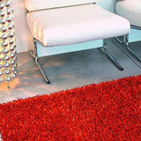 Tapis orange à poils longs en polyester – Electra, dans un salon