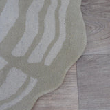 Alfombra redonda beige de pelo corto de lana – Fields Rondin – detalle del borde